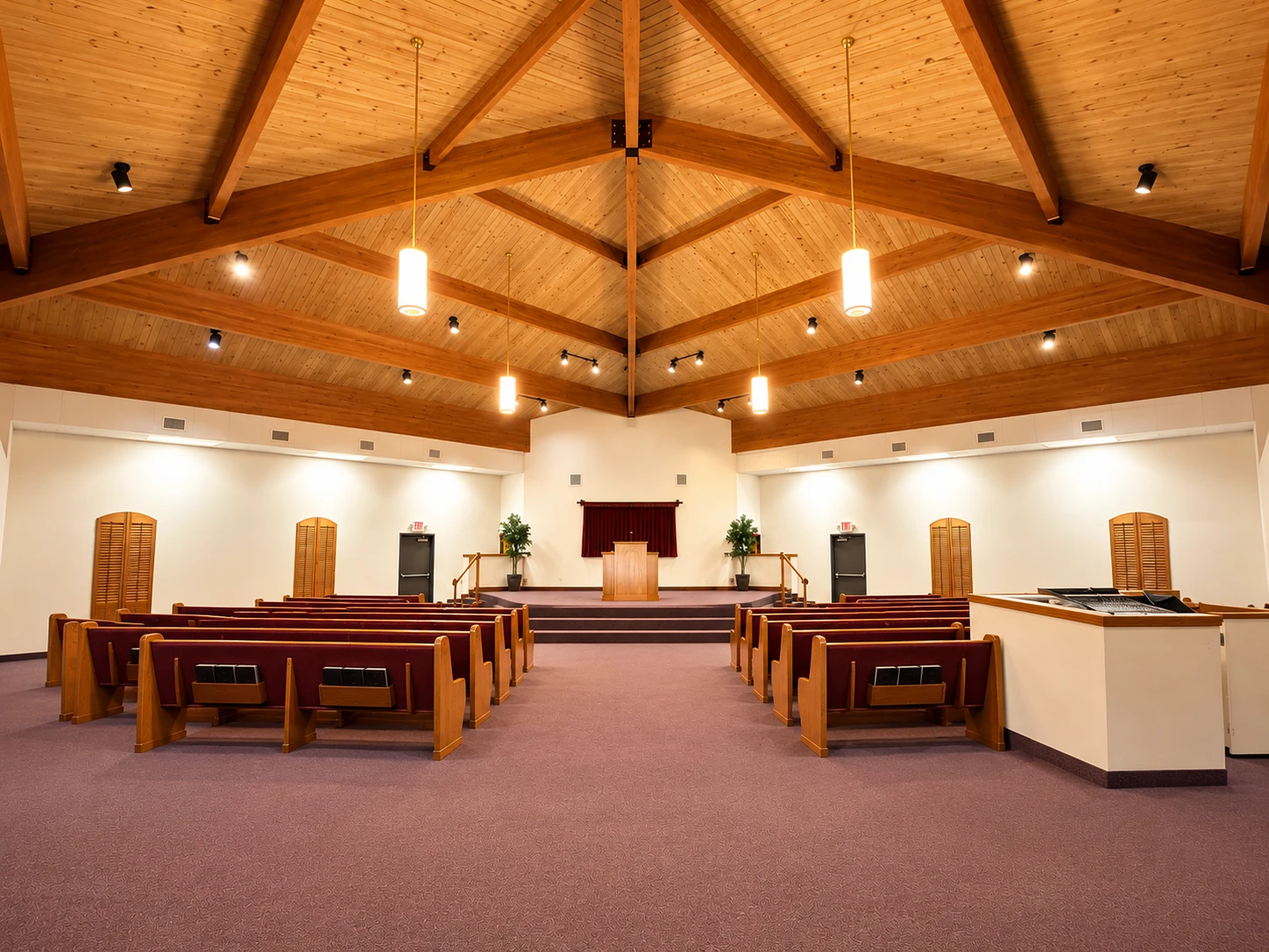 Pews in our sanctuary leading toward the pulpit